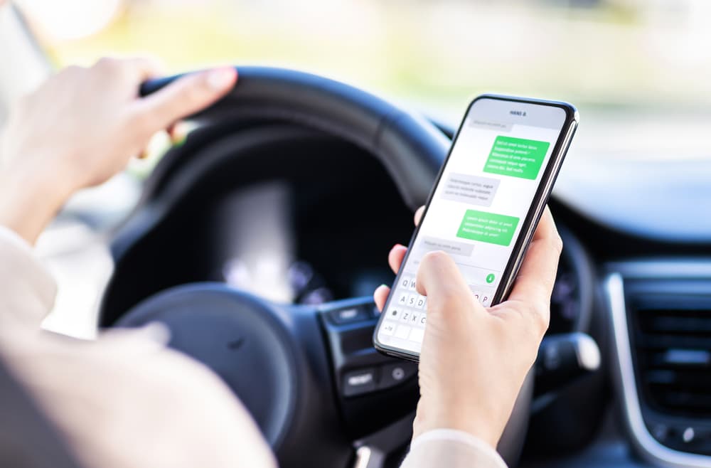 Driver using mobile phone while driving a car